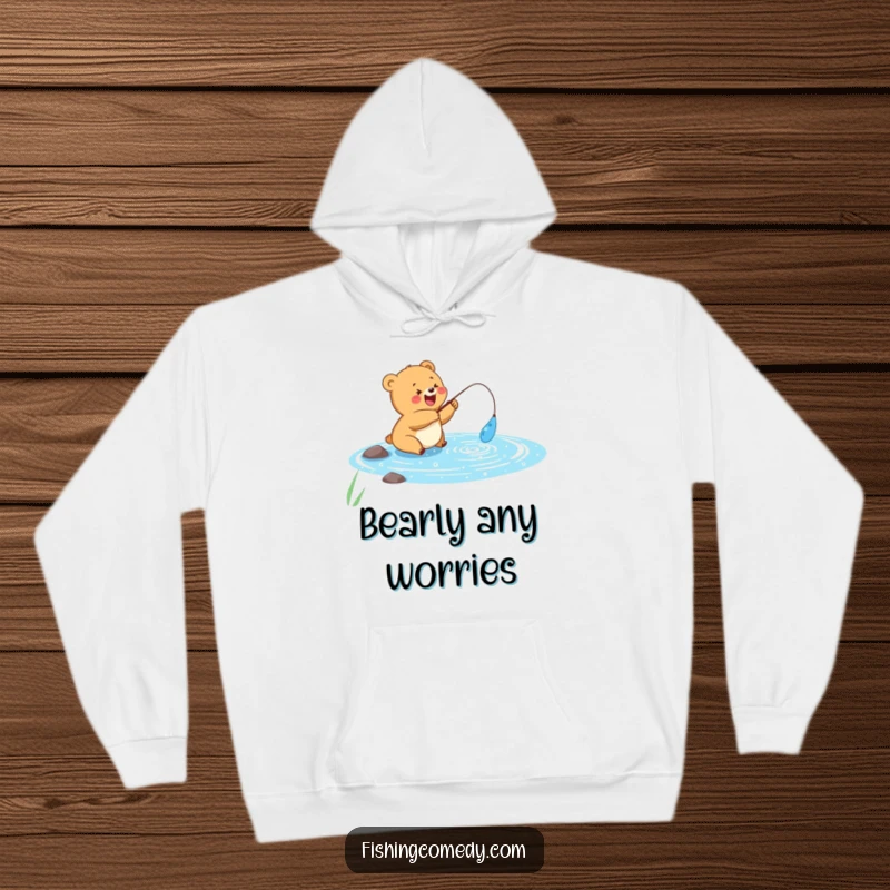 Funny hoodie with a happy bear cub fishing in a sparkly blue lake, perfect for cozy outdoor adventures, funny gift.