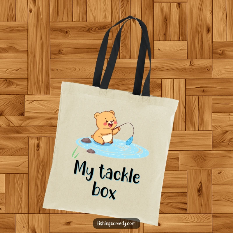 Funny tote bag with a happy bear cub fishing in a sparkly blue lake, perfect for fishing gear, funny gift.